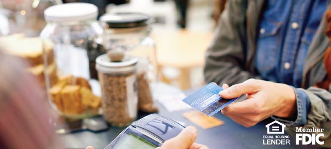 WOMEN HANDING OVER HER CREDIT CARD TO BUY SOMETHING