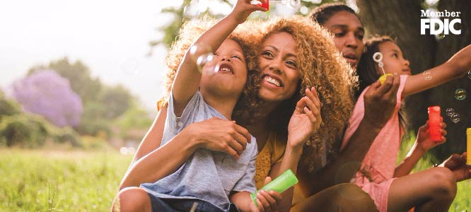 A family blowing bubbles together outside